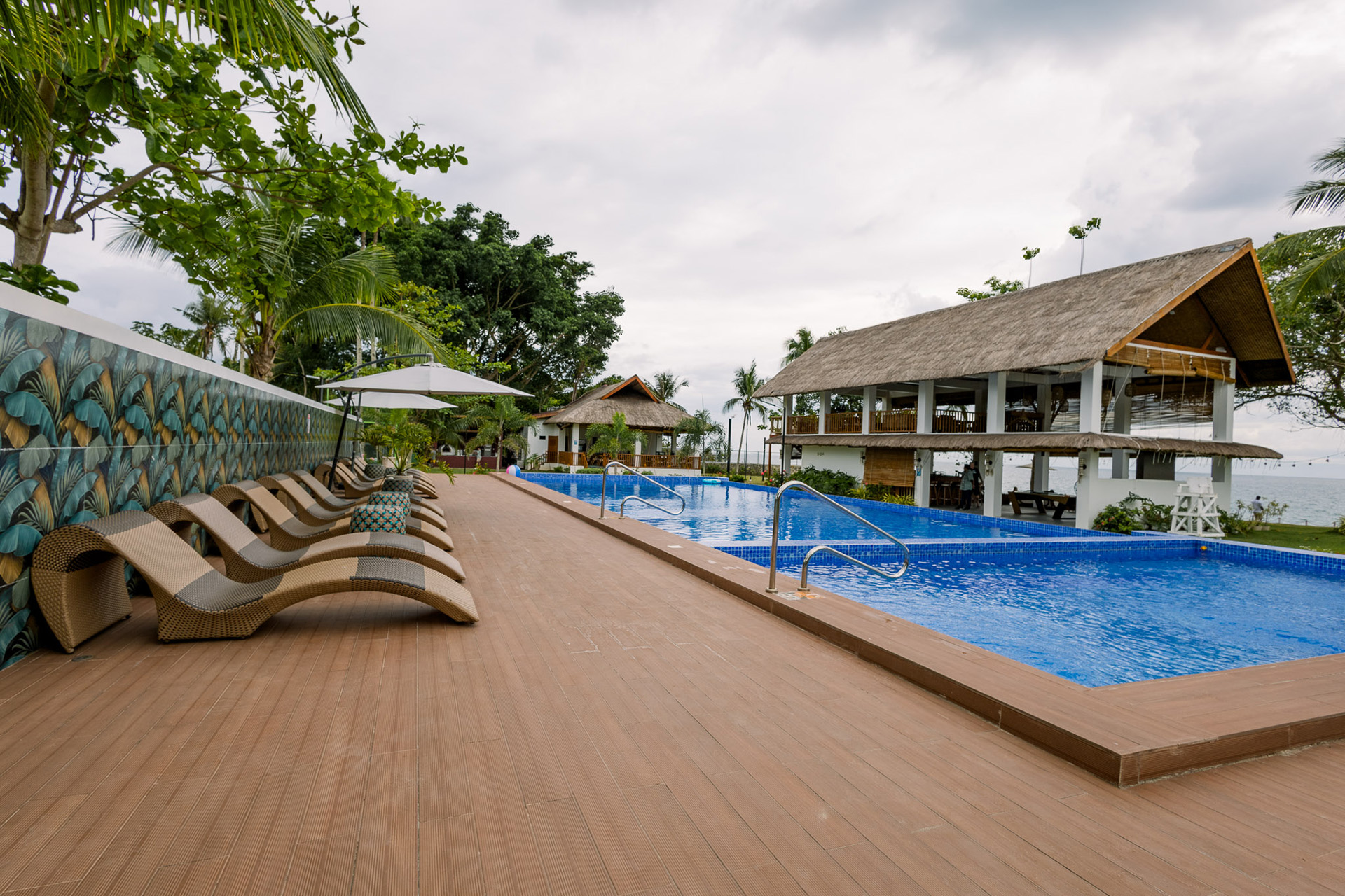 Infinity pool with sun loungers facing the ocean